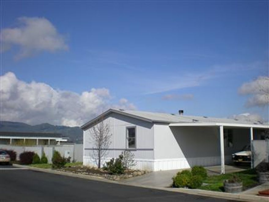 Very nice home in a great family park. Privacy homesite with mountain views. Formal entry. Vaulted living room / family room separated by see through fireplace. Large updated kitchen with breakfast area. Big master bedroom and bath with deep jetted tub, separate shower and walk-in closet. Two large bedrooms with walk-ins. Covered view deck. Two+ car carport. Large shed. Large yard. Completely fenced. New carpeting, new floors, new hot water heater, new fixtures, new paint, new duct work, new blinds, etc. Move-in ready.