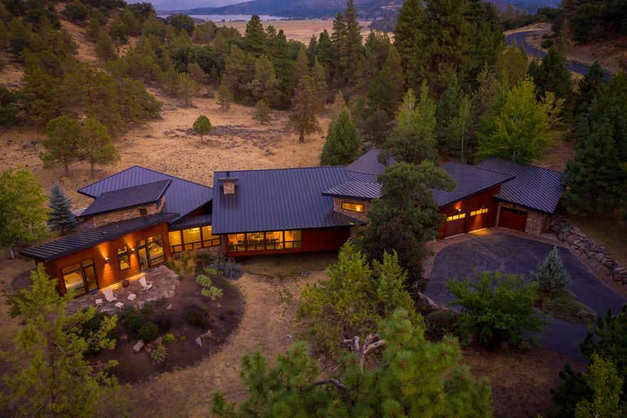 Presenting the 'JEWEL' of the RUNNING Y RANCH RESORT! This magnificent estate is truly a private sanctuary with an array of wildlife that meanders through giving you that feeling of immense tranquility.  The architecture is Northwest Contemporary & the stunning floor design blends in perfectly to the environment.   The outstanding patios offer a beautiful setting for outdoor entertainment.  The kitchen features top of the line Wolf Appliances & the island bar seats 12 easily for indoor entertainment.  The spaciousness of the interior of the home and exterior combined offers abundant entertainment potential.  All exterior & interior construction products are top of the line to include radiant heated flooring. The focal point of great room is a beautiful artist-designed fireplace. You will absolutely love the breakfast nook & office areas. There are many custom features throughout-even a temperature controlled wine cellar!   Per seller building costs were more than $2.5 million!