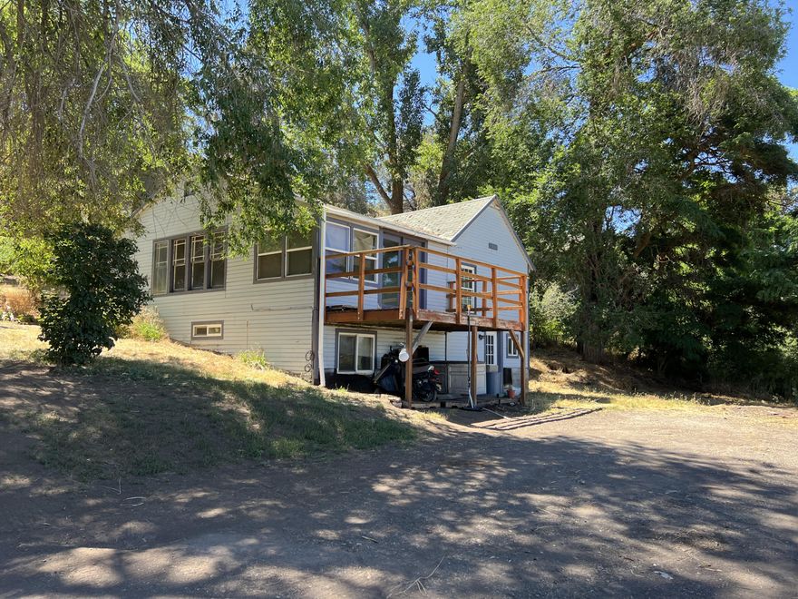 Fantastic Sunset and Views!!!  Private driveway off of Shady Pine Road with the Best Views in Oregon.  1.85-acre property features a two story 2 bed 1 bath home with 1319 sq. ft. above per assessor.  Owner added in 2008 1 bed/1 bath downstairs making this 3 bed/2 full baths with bonus room. 2022 appraisal square footage 1319. Main floor features 2 bedrooms, 1 bath, mudroom, kitchen, large pantry, dining area, large living room with large windows for natural lighting, French doors leading to balcony to enjoy breathtaking views of Mountains and Klamath Lake. Ceiling fans, pellet stove, new dishwasher, breakfast bar, laundry room, utility room, and extra storage.  Carport, lots of space for parking, Elm trees for privacy and mature elderberry, apple and wild plum trees, fenced garden area, cute patio, private well, and stairs to main road from the property.  Property needs TLC and is being sold as-is. Price increase due to installation of new composite roof and addt'l updates.