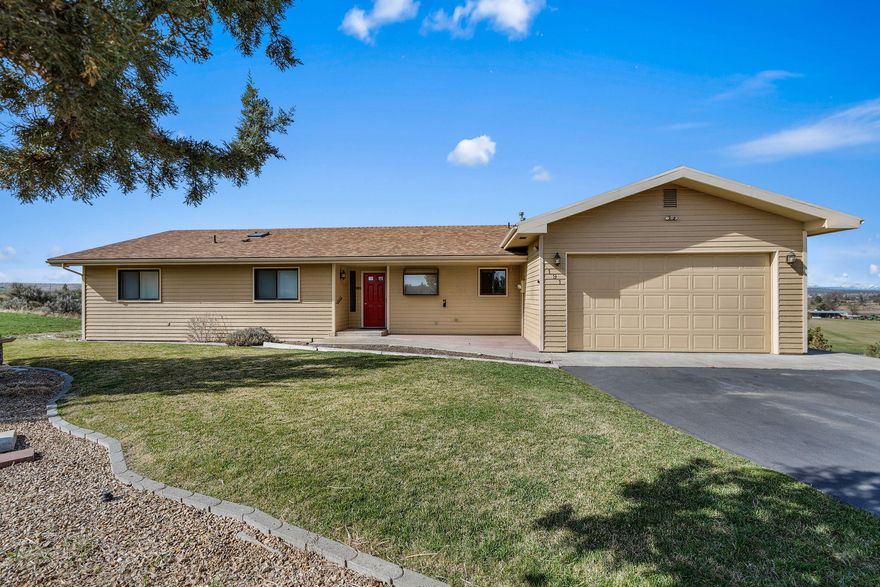 Tucked away at the end of a quiet cul-de-sac, this stunning single-level home on 2.77 acres offers privacy, convenience, and breathtaking Cascade views. Backing up to open farm fields, it provides a peaceful retreat just minutes from town. The split-style floor plan feels open and spacious with vaulted ceilings and expansive windows that flood the great room with natural light. A bay dining area surrounded by windows is perfect for enjoying sunrises and sunsets. The kitchen, updated in the last five years, features modern countertops and a full tile backsplash. Step onto the western-facing deck to take in the sweeping mountain views. With three bedrooms, two full baths, an attached double-car garage, and forced air propane heating with an owned tank, this home blends comfort and style. Enjoy the best of both worlds—seclusion with easy access to town. Don't miss this rare opportunity—schedule your private tour today!