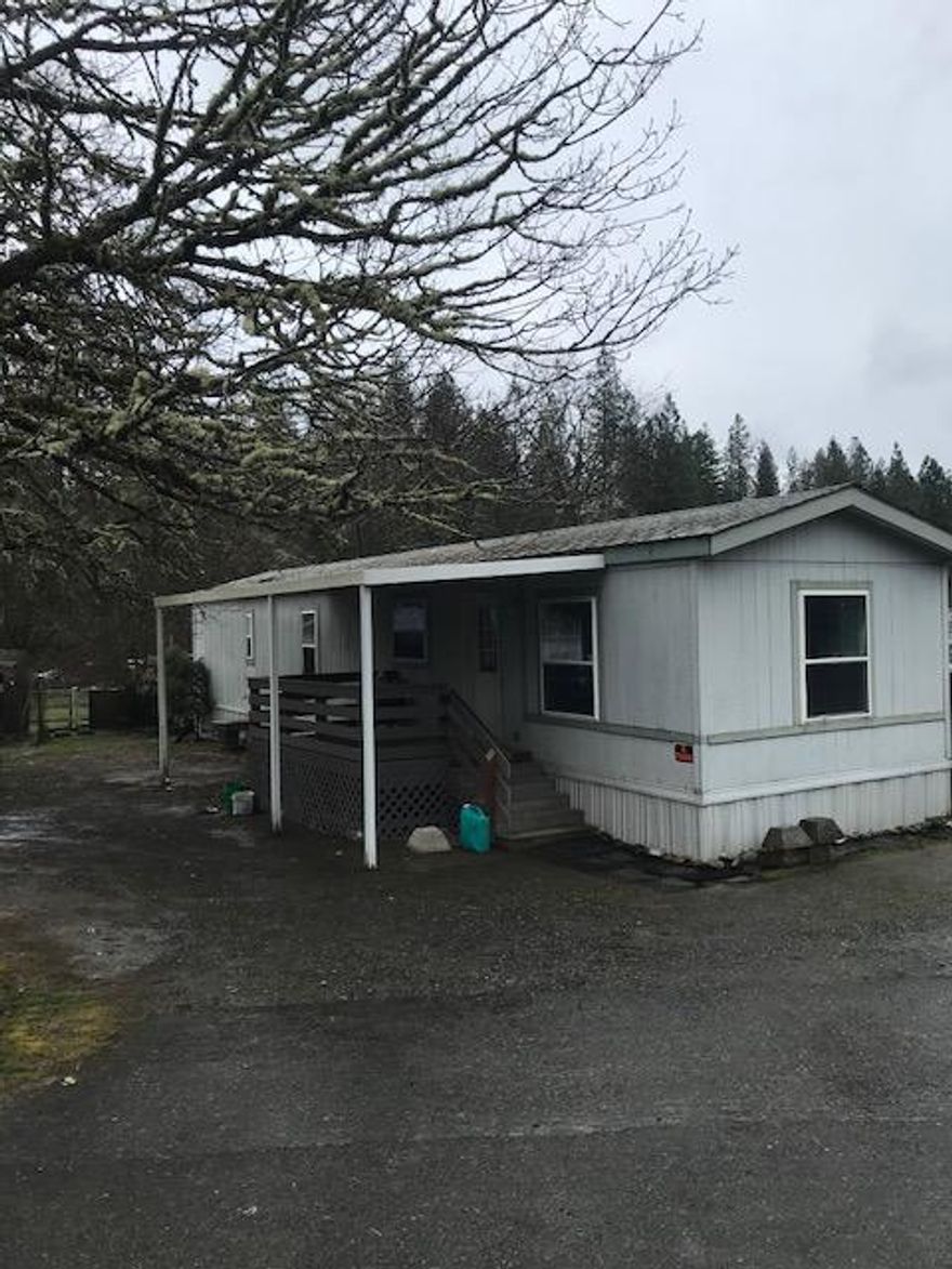The value of this property is in the land. Look through the current structures on the property, and you'll see the possibilities for this parcel. The mfg home has been damaged. The septic system is not functioning, and the seller will not repair. The well is fairly new in the last couple of years. There are outbuildings in disrepair, but usable. The 3+ acres are really beautiful, with building sites that would be easily developed. The price reflects the fact that the property needs improvements. Want to build your home on a level, easily accessible parcel? This may be the one for you!