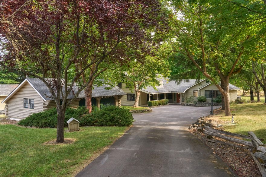 This stunning 4-bed, 3.5-bath home offers 3,540 sq. ft. of thoughtfully designed living space on approx. 5 private, usable acres with EFU zoning. The property includes over 4 irrigated acres (TID), ideal for hay production, grazing, horses or other animals. Featuring two primary bedrooms, including one on the main level, and an open kitchen with island and abundant storage, this home offers both comfort and style. Additional features include a detached 2-car garage, barn with 3 horse stalls, tack room, and hay storage. The property is complete with a large deck perfect for outdoor living, mature landscaping, and ample natural light throughout. A gated entry and paved circular driveway provide privacy and ease of access, while being conveniently located near Griffin Creek School and Medford's southwest hills.