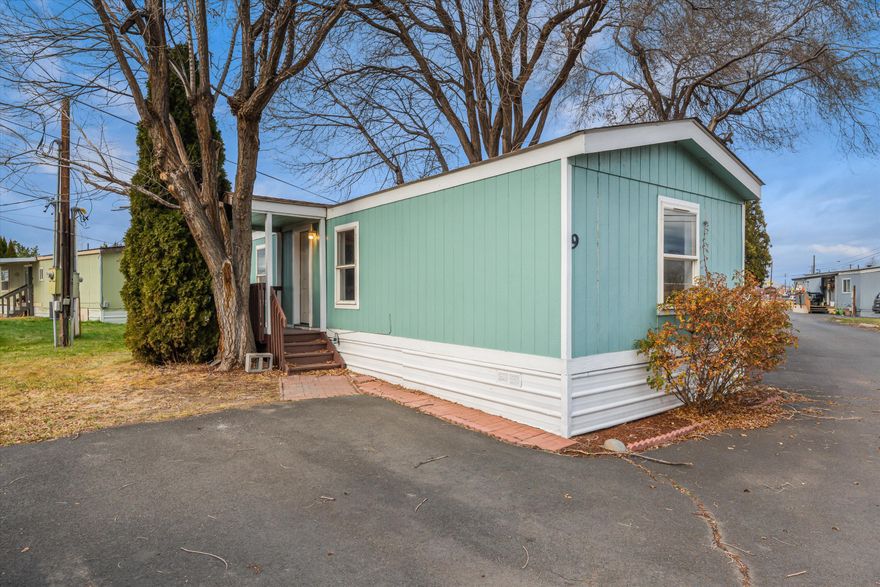 Welcome home to this charming 1994 single-wide in a quiet, well-kept park, the perfect opportunity for a new owner to make it their own. Inside, you'll find a bright and open layout with updated flooring, a spacious living room, and a cozy dining area. The kitchen offers plenty of cabinet space and natural light, and there's also an indoor laundry area with hookups so you can conveniently do all your washing right at home. Two nicely sized bedrooms sit on opposite ends of the home for added privacy, and the bathroom has been tastefully refreshed with modern tile and finishes. Outside, enjoy a corner lot feel with mature trees, extra parking, and a small lawn area ready for your personal touch. Affordable, functional, and full of potential, this home is ready for someone to love it just as much as the last owner did.