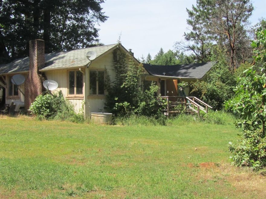 Investors delight, AS IS gorgeous area on riverbanks Rd. consisting of 6.87 beautiful acres near the Applegate River and not far from town.This home is in need of major repairs, so bring your RV and your horses to this 3 stall barn, could be 4, each with their own paddock and they can enjoy the large arena while the renovation of the home takes place. Also has a shop and shed for storage. Assessor has this as a 4 bedroom, 1 bath but it is actually 3 bedrooms & 2 baths.