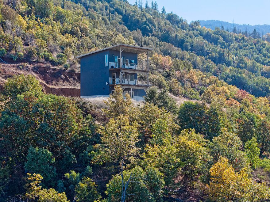 Imagine creating your dream farm on 28+ acres of EFU farmland, surrounded by breathtaking views of the valley and mountains! The main home boasts three levels, each with its own bathroom and a deck to take in the stunning views. The radiant floor heating throughout ensures warmth in Winter and there are washer / dryer hookups on the lower floor. The potential for each level to be a separate rental unit provides a lucrative opportunity. The impressive ag building includes a room w/roll up door, a guest room with a full bathroom, a farm office space above and a deck to take in stunning views. Both structures are powered by solar energy. A large chicken house is ready for commercial chicken production or a great multi-use structure. Property is fenced and cross-fenced, ready for your animals, and features a fenced garden area. Good well flow per seller. All this and only a 5 minute drive to amenities and 10 minutes to downtown Ashland.