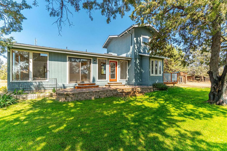 Immerse yourself in the tranquility of this five and half acre parcel nestled directly between the Deschutes and Crooked River Canyons, and find your peace. A cozy stick built home invites you in through a stand of mature junipers. With a vaulted great room floor plan and large wood wrapped windows, the main living space is flooded with natural light. The main level primary suite includes a full bath with soaking tub surrounded by windows for a private view of the property. Also downstairs, a dedicated office and a half bath. The upper level offers a second possible primary suite with adjacent bath and private entrance. A true hobby farm, this property provides plenty of room to build the shop of your dreams, equine facilities and immaculate gardens. Spend your days fly fishing at Steelhead Falls, hiking around Smith Rock State Park or enjoying the many amenities of Crooked River Ranch including golf, pool, tennis/pickle ball courts, restaurants, parks and trails.