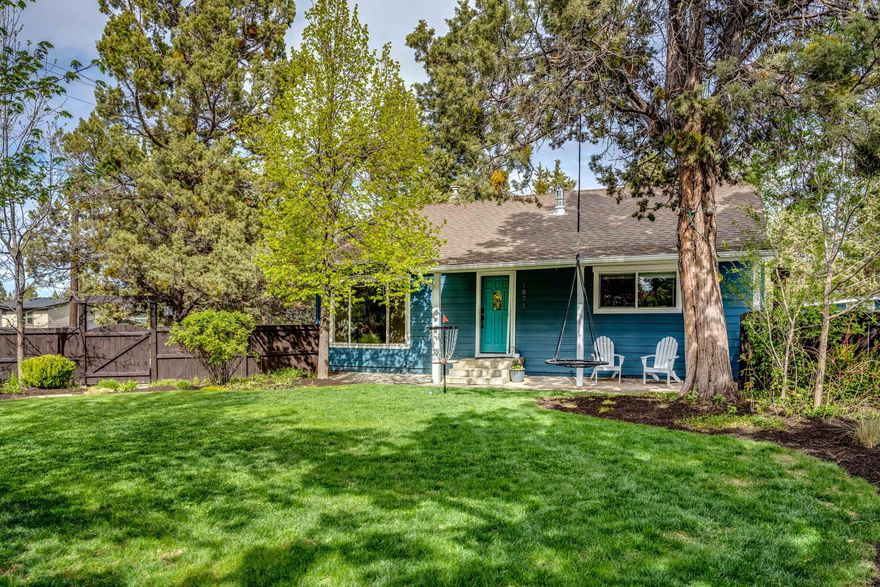 Updated 1950's Ranch style home in Midtown! Living room features newly refinished hardwood floors, shiplap ceiling, gas fireplace w/mantel & custom built-ins. Stylish kitchen includes tile backsplash, cement countertops, stainless appliances w/ breakfast bar, pantry & eating area. Spacious primary bedroom features huge walk-in closest w/built in shelving, spa-like bathroom w/subway tiles surrounding jacuzzi tub & walk in shower.  Spacious bedrooms w/custom bunk bed & play loft. Fully fenced front yard beautifully landscaped w/Avion irrigation. Backyard features a paver courtyard & irrigated lawn. Thjs home sits above Bear Creek Road & has private road access to the main parking area, front door, and garage. with TONS of parking. Plenty of room for RV's, boats, etc. The detached garage has workshop area & plenty of storage along with 180 sqft unfinished basement. The lower area on Bear Creek Road could be the perfect spot for an ADU.