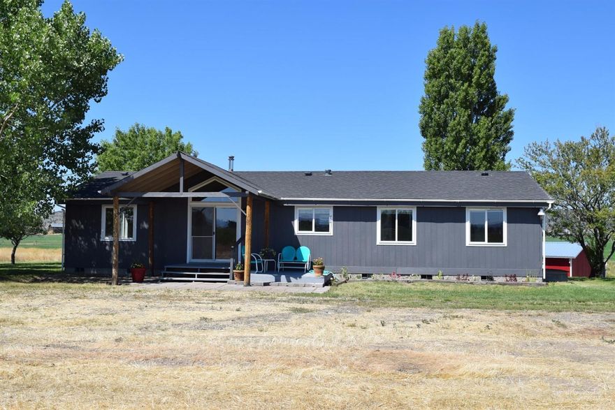 9.8 Acres, home sits up on a knoll to enhance the views, surrounded by a timeless Buttes and Foothills in the distance. Spacious 1456 Sq. ft. mfg home with vaulted ceilings, 3 bedrooms, 2 baths (split rooms,) stainless steel appliances, new laminate flooring in living area, new paint inside and out. Handy outbuilding. Over 9 acres with irrigation rights ready to till and plant and irrigate. Great potential and the perfect setting with shade trees. Minutes from town and the new state of the art hospital.