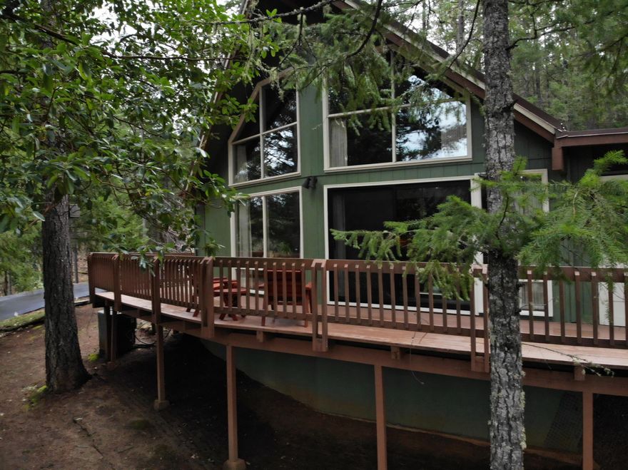 Welcome Home! Very well maintained A-Frame chalet style home located minutes away from the Rogue River Recreation sites. The main home features 2 nice sized Bdrms, 2 Bath, with the primary bedroom on the first floor. The living room offers large view windows and a vaulted ceiling that an A-frame offers! The kitchen has granite counters and stainless steel appliances. The laundry area is off the main floor bathroom. The large deck wraps around 3 sides of the home and there is a covered screened in area on the deck. Also a nice patio area. There is a detached bonus room that can be used for a 3rd Bdrm/Office. There is a 2 Car detached garage that was constructed for a second level to be built. Don't worry about storage, there are plenty of areas. Gated & Paved Driveway. This home has a lot to offer in your own forested location. Wildlife visits everyday. Air B&B Potential? RV Parking. Buyer to do their own due diligence as to the condition and uses of the property.