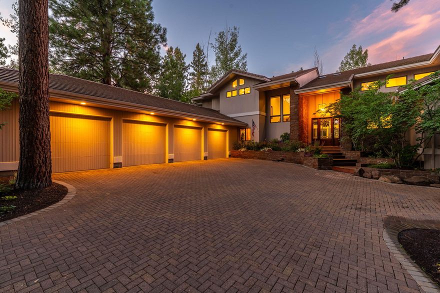 Sophisticated, serene, & newly enhanced, this Broken Top sanctuary exemplifies modern luxury in one of Bend's most coveted private communities. Beneath a canopy of mature pines and at the end of a quiet cul-de-sac, this timeless residence has been thoughtfully upgraded throughout. Voluminous ceilings, a striking floor-to-ceiling stone fireplace, & expansive walls of glass create a dramatic yet inviting living experience. A brand-new, expansive deck sprawls across the private backyard—perfect for elevated outdoor entertaining & enjoying the golf course view. Purposefully designed for both grand gatherings & quiet moments, the open floor plan offers sunlit living spaces, and generous accommodations with 4 en-suite bedrooms. A rare, oversized 4-car garage provides exceptional storage & flexibility. Just a short stroll to the private clubhouse, golf course, driving range, & minutes from Bend's top-rated schools, trails, & downtown. Enjoy luxury living in Bend's finest gated community!