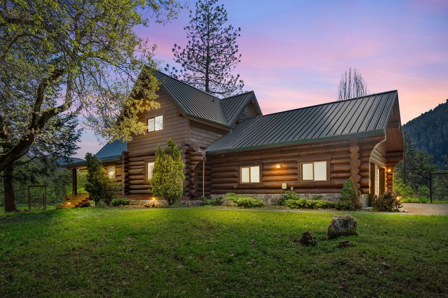 *OWNER CARRY FINANCING AVAILABLE* Breathtaking Applegate Valley property offering a blend of rural living and modern amenities. Set on over 37 acres, the estate features ½ acre of grapes, 10 acre pasture along with irrigation rights from 1894- perfect for the wine enthusiast or hobby farmer! The open-concept log home boasts hickory floors, vaulted ceilings, and gourmet kitchen w/ high-end stainless steel appliances and granite countertops. The primary features a luxurious updated bathroom w/ heated stone floors, glass shower and separate soaking tub. Equipped w/ brand new solar panel and battery system, the home has the option to run completely off grid, along with gig fiber and wifi system providing internet to all buildings. Other recent upgrades include a new water heater, a new heat pump, and new redwood deck. Outside, a fully finished and air-conditioned 42x42 shop includes four separate rooms and space to park an RV. Additional outdoor features: 2-stall barn + garden shed.