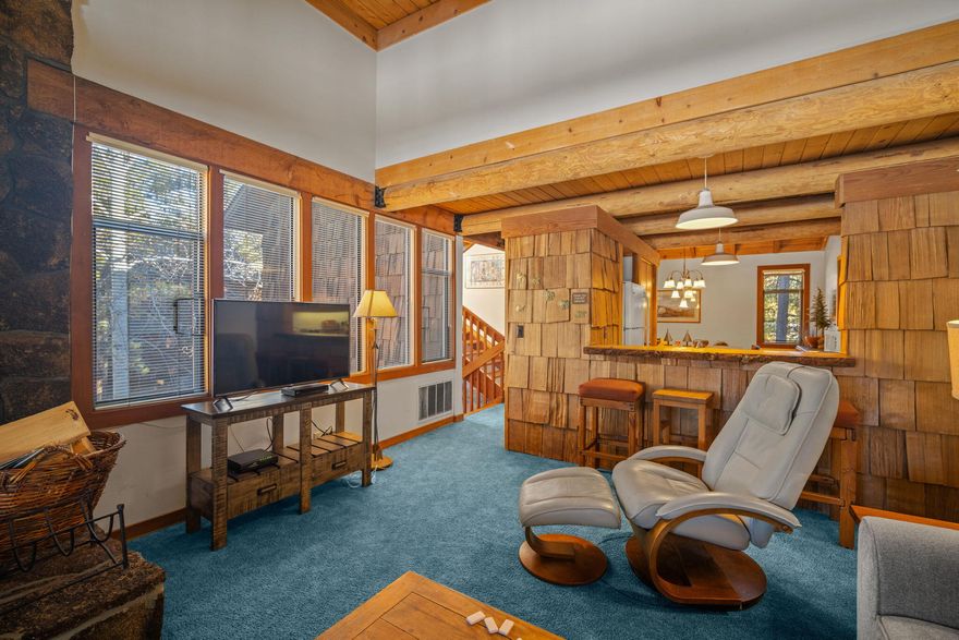 Nestled along the 12th fairway of the Meadows Golf Course, this charming condo offers stunning views. The primary suite features a cozy wood-burning fireplace, a private balcony, and golf course vistas. The second bedroom is equipped with a king bed and a bunk, providing ample space for family or guests. Upstairs, the dining room seamlessly connects to the kitchen, which is highlighted by a skylight that brightens the space and leads to the rooftop deck. The breakfast bar doubles as a convenient pass-through to the living room, where large windows and a slider open to an upper balcony. Wildflower Condos are ideally located across the street from Sunriver Village, filled with restaurants, shops, and seasonal entertainment. Nearby, you'll find the SHARC Aquatic Center and the Sunriver Lodge, making this condo the perfect basecamp for all the amenities Sunriver Resort has to offer. Turnkey and equipped with AC, 30 Wildflower is ready to be your home away from home or investment dream!