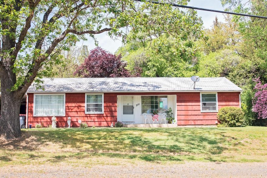 Lovely East Medford home with stunning mountain views. Spacious, open living spaces with the original hardwood floors. You'll be amazed by all the built in storage in the kitchen, and the other unique features throughout the house! Natural light brightens the inside of the home, while the large surrounding yard is comfortably shaded by several mature trees. Off the kitchen is a covered porch great for a barbecues and entertaining, and the front porch is a great spot to sit and enjoy the beautiful scenery. This home has a lot of 50's charm! Schedule a showing today!