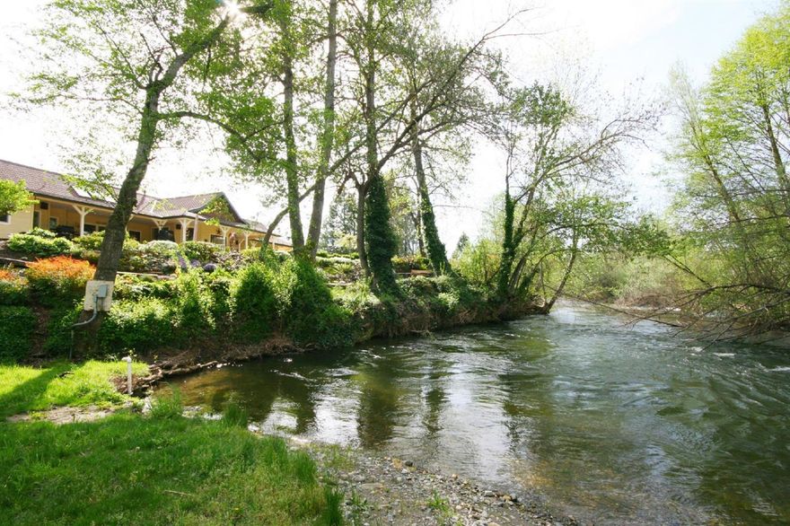 Applegate River Perfection! Australian Farm House overlooking the River. Large windows & skylights throughout. Large master w/ walk-through closet & bth w/ double sinks & large shower w/ multiple faucets & sitting area. Mirrored living spaces, one w/ a cozy propane fireplace, the other w/ large media cabinet. 2 guest rooms, 2nd bth & a good sized sewing/hobby room on the opposite end from master. Large open kitchen/dining area w/ island is filled w/ natural light. Attached 3 car carport is designed for an easy conversion to garage if desired. Extensive outdoor living w/ 1400 sf of wrap-around covered decking, large patio area w/ propane fire pit & beautiful landscaping. 8.64 acres, 1200 ft of river frontage, mature trees & perfect privacy. Large yard w/ fruit & Pine trees. 60x72 barn includes 2 finished rooms w/ loft storage above each, 36x24 corral, mult. shop areas & RV hook-up. Fenced, irrig. pasture, garden area w/ raised beds & drip irrig. Owner is Licensed Broker in Oregon.