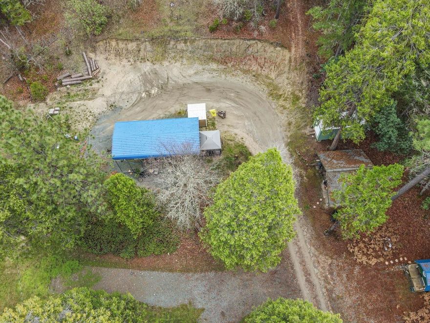 This exceptional 6.11-acre parcel offers the rare and highly valuable benefit of all major utilities already installed, saving you significant time, money, and permitting hassle. Located in the beautiful rural area near Rogue River, Oregon, this is the perfect canvas for your custom home, cabin, or serene retreat. 

This property is perfect for anyone looking to bypass the extensive site work and permitting usually required for raw land. Start designing your home and breaking ground sooner!

The land is primarily forested timberland, providing a beautiful, private, and quiet setting. Mature trees offer potential for marketable timber or simply a stunning, natural backdrop. There is also a seasonal creek that runs through the property.

Buyer to conduct their own due diligence regarding the property and permitting of home. Metal car port to stay with property valued at $8000. 

**Do not drive on property without representation of agent.**