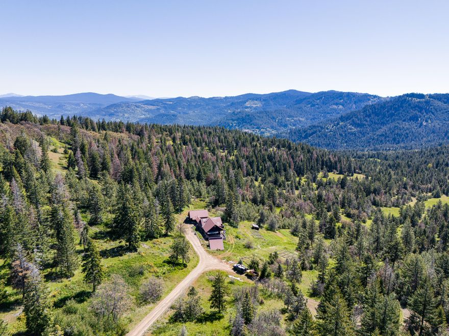 Experience the beauty of all seasons at this stunning 1270-acre ranch in the Siskiyou Mountains, just 30 minutes from Ashland! Revel in breathtaking local & territorial views that encompass forests, alpine meadows, & the iconic Pilot Rock. From the comfort of the 2372 sqft home, soak in panoramic vistas that include major landmarks within 100 miles, such as Mt. Ashland, Table Rock, the rim of Crater Lake, Mt. McLaughlin, Mt. Shasta, & Pilot Rock. At the property's highest point, an inactive cellular tower offers a 360-degree view, with potential to be a private lookout! A conservation easement offers the protection of natural resources while allowing for property use & enjoyment. Additional features include 2 ponds, seasonal streams, internal roads, abundant wildlife, & proximity to the Pacific Crest Trail. Though the house is structurally sound, it requires some TLC. A portion of the property lies within the Cascade-Siskiyou National Monument, with easy access to local services & I-5