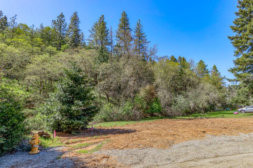 This beautiful .50 acre lot is located on South 3rd Street in city limits with creek side living and your own forest in the backyard comes with water and sewer all at the lot and ready for you to build your dream home! Very easy to build on. Recently surveyed with building envelope clearly marked. Very quiet and private, and a short walk or bike ride to downtown Jacksonville shops, fine dining and concerts under the stars at the Britt Festival