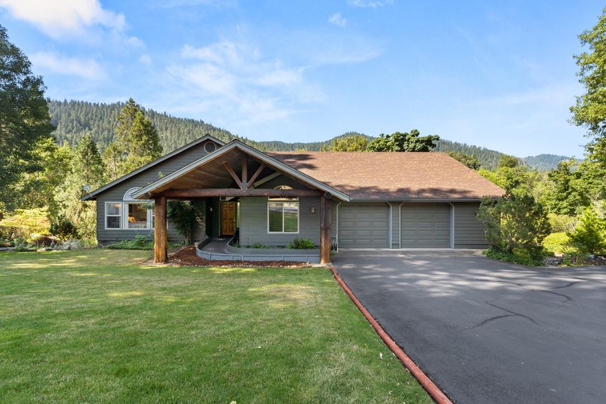 Riverfront dreams do come true! Nestled on 1.6 acres of prime Rogue River frontage, this 3-bed, 3-bath retreat offers jaw-dropping views and the ultimate in river living. Inside, rustic charm meets comfort with vaulted ceilings, exposed knotty pine beams, hand-carved wood floors, a stunning river rock fireplace, and natural light pouring in from every window. The spacious layout includes a bonus room ideal for an office, den, or home gym. The massive primary suite is a true sanctuary—complete with a walk-in closet, en suite bath, and private access to a sprawling deck overlooking the river. Whether you're sipping coffee at sunrise or watching the wildlife at dusk, this home delivers peace, beauty, and inspiration. Just minutes from downtown Grants Pass, top schools, and medical care, yet it feels like your own private lodge. Love fishing, rafting, or nature? This is the one you've been waiting for.