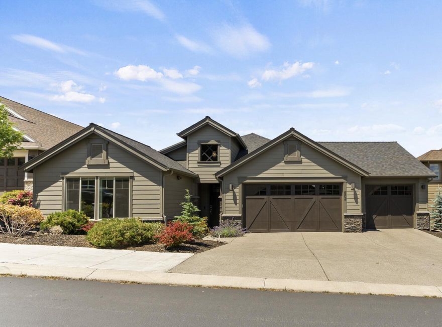 Welcome home to this beautifully crafted single-level residence, quietly nestled on a no-through street above River's Edge Golf Course, offering views of Smith Rock and the eastern buttes. Originally built by Pahlisch, this property has been enhanced by the seller to include a unique, light-filled bonus room or large office in addition to 3 spacious bedrooms—each with an adjacent full bath. Step through the wide entryway into the expansive Great Room, which opens onto a private 450 sf Trex deck, surrounded by trees and framed by grass and open skies. The home's thoughtful design includes 9-ft ceilings, 8-ft doors, wood and tile flooring, soft-close cabinetry, KitchenAid appliances, quartz countertops, and beautifully tiled showers. The spa-like primary view suite is bathed in natural light and offers direct access to the hot tub. A highly sought-after 987 sf garage features epoxy flooring, a utility sink, and ample custom storage.  All this just steps from the Deschutes River Trail.