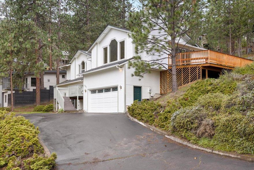 Come for the amazing forest views, stay for the light-filled rooms, space, and sense of privacy. The upstairs was recently updated with fresh paint and all new luxury vinyl plank throughout. It looks fantastic! The kitchen has new quartz countertops and painted cabinets, and both an eating area and a dining room. The wraparound deck is perfect for entertaining and extending your living space to the outdoors. Three bedrooms and two full baths upstairs. The oversized primary bedroom features amazing views, built-in bookcases, a walk-in closet and en suite bath. Two other bedrooms are large, with ample light and views of the back yard. Gas fireplace in the living room and pantry off the kitchen feel like luxuries. Downstairs you will find a one-bedroom apartment complete with kitchenette, full bath, and separate entrance. Perfect for guests or mother-in-law unit. Generously sized two-car garage, plus a paved off-street parking area. Shared driveway. Just minutes from downtown Ashland.