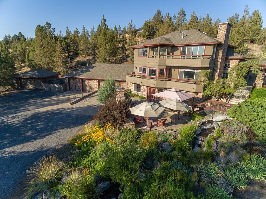 Rare Tumalo custom home with amazing mountain views on private 3.41 acres. 4,412 Sq.Ft. contemporary style home built to take full advantage of the tranquility and peacefulness of this beautiful property. Master suite with mountain views, partially covered deck, fireplace, jetted tub, walk-in shower and 2 walk-in closets. Large guest suite with walk-in closet and updated full bath , 2 additional bedrooms and 2 updated full baths. Open great room with gas fireplace, spacious kitchen and mountain views from every window. Flex space with built-ins that leads to side patio. Downstairs bonus room with full bar for entertainment, gas fireplace and additional storage room and mudroom. Gorgeous outdoor paver patio with large stone fireplace and cascading water feature. 5 oversized garages with heat, water, built-ins and an additional ¼ bath. RV parking with hook-ups, shop/barn and corrals. Lush lawns with separate garden area and large pond. Too many features to list, this home is a must see.