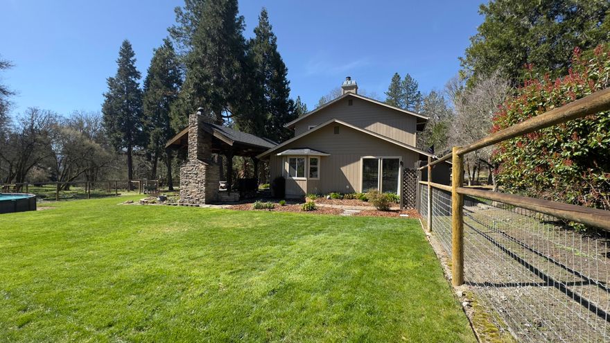 First time on the market! This 5-acre horse property is ready for horses or a mini farm, featuring a remodeled master suite with a spa-like bath, dual shower heads, heated floors, and a walk-in closet. The main level showcases Brazilian cherry hardwood floors, two spacious living areas, a formal dining space, and a gourmet kitchen with ample workspace and a pantry. The large fenced and irrigated yard offers a covered patio with exposed beams and an outdoor fireplace, perfect for entertaining. Two seasonal creeks, a horse stable, and a small arena make this property truly unique. Thoughtful upgrades throughout. Just 5 minutes to downtown Grants Pass, offering convenience with a peaceful country setting.