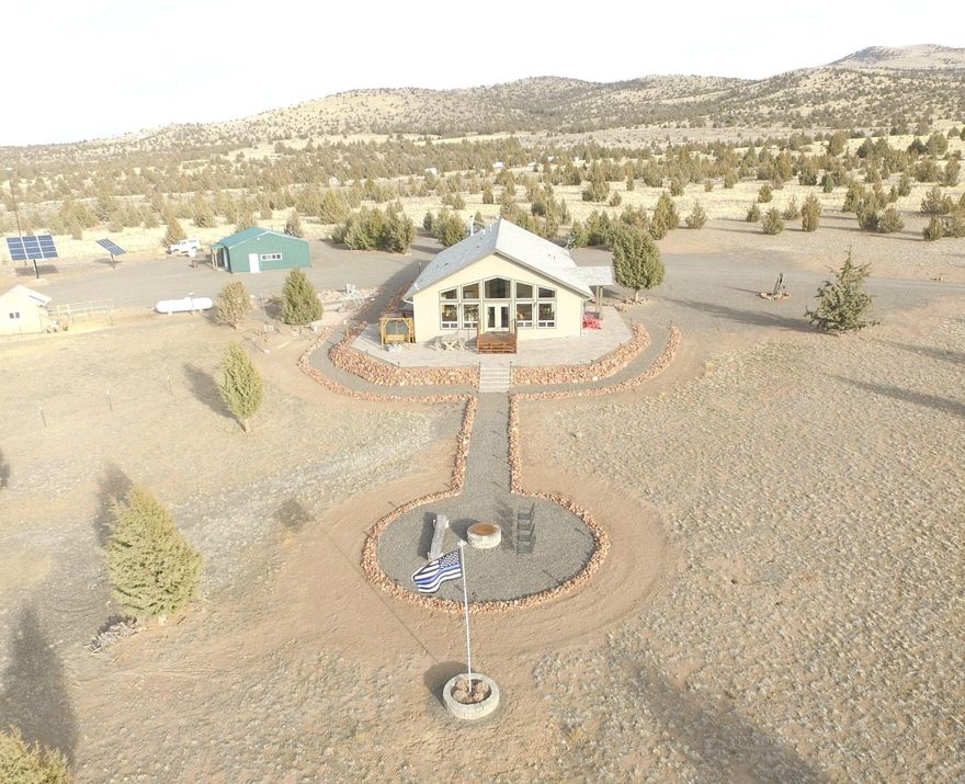 Off-grid living with a million dollar view of the Cascades and spectacular sunsets. This home features an open concept living room, kitchen and dining area and two decks. There are no monthly utility bills to pay with a state of the art solar system, 14kw back-up whole home propane generator, a 1000 watt Bergey wind generator that keeps the batteries topped off with as little as a 6 MPH breeze and 7500 gallons of water storage. Insulated shop with propane heat, stainless steel sink and composting toilet. This 40 acre property is fenced on three sides and includes a solar powered entry gate. Home is supplied with a Ring security system with four Ring cameras and a driveway alarm. Co-owner is a licensed Real Estate agent in the state of Oregon.