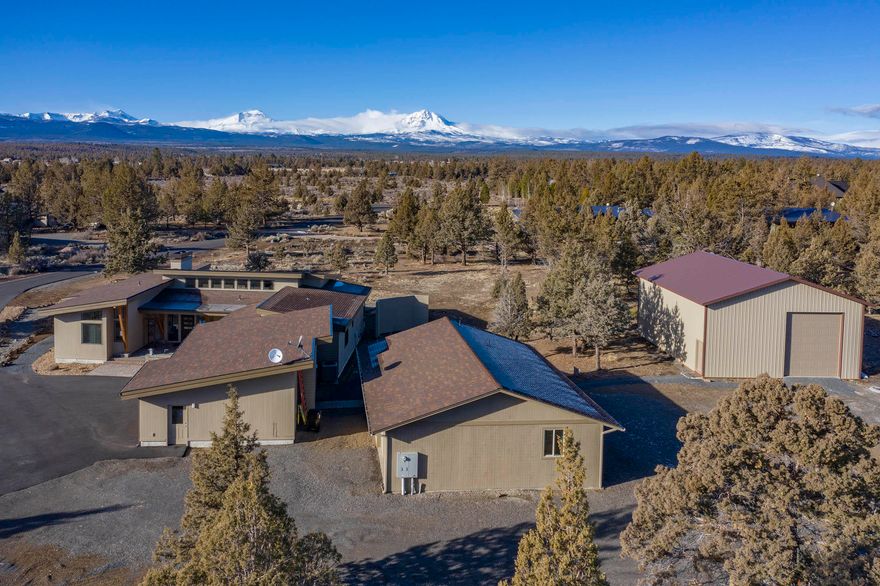 Cascade Mountain Views! Private country living with room for all your toys. Located between Bend and Sisters. Plainview Ranch. Mid-century modern, 3-year young, 2738 sq.ft. single level, custom pristine Gary Laursen built home. 3 bedrooms, office, 2.5 baths (3rd bedroom is movie room). 1200 sq.ft. single level heated shop with 200A service, 1/2 bath. 33 x 40 single level RV shop/barn with two 14 foot roll-up doors. 4.68 low maintenance acres on paved road. Mountain view from all west rooms. Pella wood windows, Coleman heat pump, custom curly maple wood front door & cabinets in great room. Solid maple floors, vaulted ceilings, gas fireplace, kitchen with slab granite counter tops with 9'' slab granite island. Bosch wall oven, Dacor microwave, Bosch gas cooktop, 2 Bosch dishwashers, pantry. Master suite and office separated, 2nd bedroom, 3rd bedroom is movie room. Master bath has radiant floor heat, soaking tub, towel warmer.