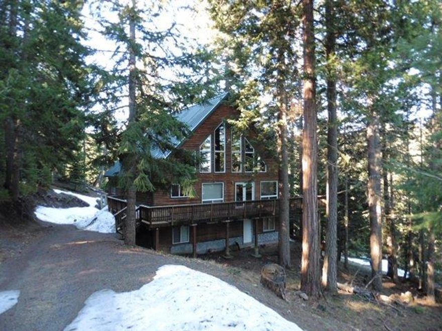 Awesome home among the trees! This is a great place to get away from it all and is close to the lake. Home offers garages and a workshop on the ground level. Large living room with soaring ceilings, fantastic windows and a fireplace that open to the well appointed kitchen area. 2 bedrooms on the main level and 2 more rooms on the upper level. Worth the drive to a fantastic retreat.