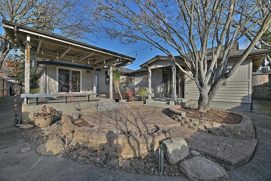 This beautifully maintained 3-bed, 2-bath home offers 1,192 sq ft of updated living space on a manicured 0.14-acre lot in desirable NW Grants Pass. The main home features ductless heating/AC, a newer roof, updated siding and paint, plus gorgeous landscaping and hardscaping. Inside, enjoy marble kitchen counters and backsplash, a neutral color scheme, and laminate flooring throughout the living areas. Outdoors, entertain or relax in the spacious yard with RV parking, ample side-yard storage, a rollup-door unit, and workshop. The standout bonus? A charming accessory dwelling unit with kitchenette, full bath, and large walk-in closet — perfect for multi-gen living, guests, or rental income. This move-in-ready property is a rare gem!