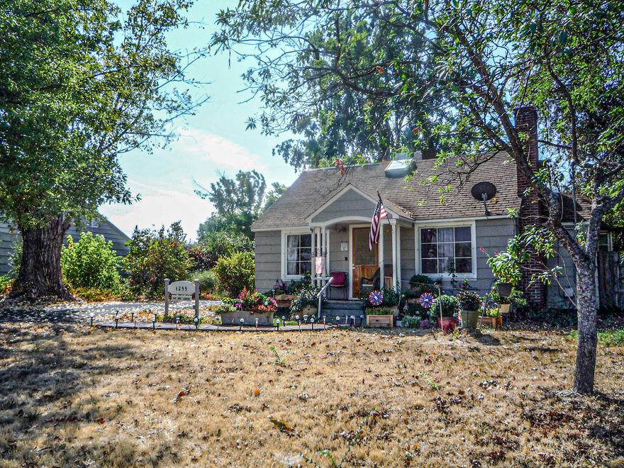 This delightful cozy home has custom built-in cabinetry, drawers and pull outs throughout the whole house. The main level features vintage hardware and fixtures, solid oak and fir floors, spacious living room with fireplace, Nook with bench and bay window, kitchen with commercial-grade gas range/oven, pantry, dining area with built-in buffet and bench, two bedrooms, full guest bath, laundry room, and mudroom. Upper-level has a bedroom with vaulted ceilings, skylights, kitchenette with fir floors, office sitting area, and full bath with pedestal sink and tub. The home sits on a serene 1.23-acre parcel with mature trees and multiple outbuildings, shop, large decks with pergola in Southwest Medford! The huge, over 1,000 SqFt. workshop has a woodstove, frig, and all the wood working machinery included, detached 2-car garage, custom-built gazebo, redwood sauna, chicken coop, and treehouse. Back addition was built in 1946, Original house was built in 1920. Must see to Appreciate..