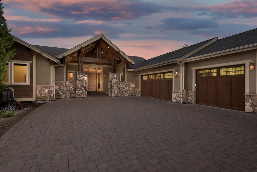 Exquisite custom home offering luxury, privacy & views, with minimal yard upkeep. Quality finishes & craftsmanship throughout, including walnut hardwood floors, wood beams, cabinetry & trim. The open-concept great room boasts vaulted ceilings, grand stone fireplace & a chef's kitchen with granite slab counters, double oven, wine fridge, 2 dishwashers & large walk-in pantry. Main level features spacious primary suite & bath, office, laundry & expansive deck overlooking Pilot Butte and the golf course (east facing remote shades). Lower level includes large bonus room with wet bar, 3 bedrooms (all with lower deck access), 2 full baths, wine room & second laundry. Oversized 3-car garage & under-house storage add convenience. Enjoy outdoor living with a paver driveway/patio & tranquil water feature. Located at the end of Fairway Heights above the 1st fairway at Rivers Edge. Built by award-winning Clearview Builders. A stunning home with space, light, privacy & timeless elegance.