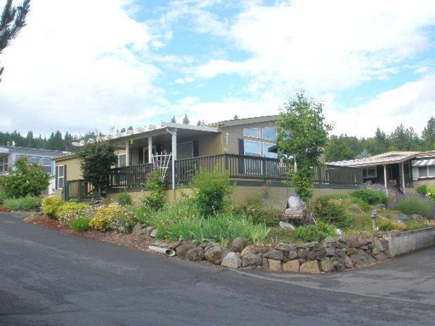 Meticulously maintained home located in one of the most desirable park, Western Carriage Estates 55+ park. 3 Bedrooms and 2 baths, 1296 sq.ft. vaulted ceilings. Storage unit, one car covered carport and one extra car parking. Leisurely sip your drink while lounging on the deck that overlooks the valley and night lights of Medford. Park amenities include a clubhouse, pool hall, library, heated pool and secured RV storage with RV dump. Park allows one small pet. Park fee includes water, sewer and trash. For obtaining a loan, call Rick Budahl at Northwest Housing Services, 1-877-467-9144