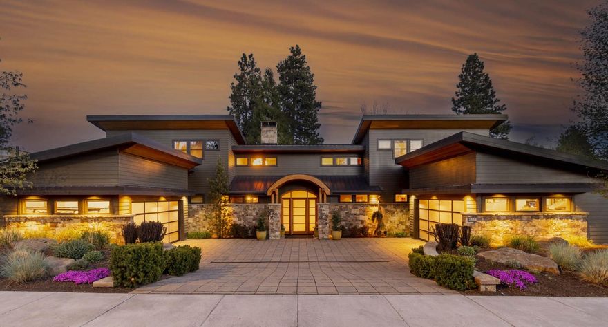 Whether you seek to live in the heart of it all, or are looking for a retreat away from the hustle & bustle of Bend, you'll find it here on First Street. This mountain-modern home blends extensive fir, & stone accents, w/ concrete, recycled glass, & oil-rubbed metal features. An expansive wall of windows extend to the two-story ceiling & frame the river views. Bifold doors open wide to usher in the soothing white noise of the First Street Rapids. The kitchen is a chef's dream, featuring concrete counters, custom walnut cabinetry, & top-of-the-line appliances. The main-level owner's suite features a gas FP & bifold doors to the back patio w/ Marquis spa & custom sauna. In the lower level of this home, find a huge media/game room, 800+ bottle wine room, & hobby room. Three more ensuite bedrooms are on the upper level. On the covered patio, enjoy a built-in grill & bev. fridge, patio heaters, & fireplace. A large lawn spans the 100 feet of river frontage. This home is a sanctuary!