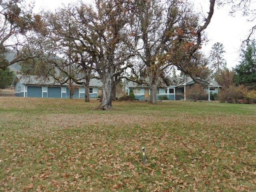Beautiful setting with awesome oak trees and views of the mountains and vineyard. Located in Ruch and sits back away from the road on quiet acreage. Property offers lots of flat land and a detached garage shop with 3 bays and a car port. Inside offers a light filled living room with a wall of windows to take in your surroundings, dining area with harwood floors and a large, very usable kitchen. Split fllor plan offers a large master suite on one end with tons of storage and a large master bathroom with jetted tub and shower. The other end of the home offers 3 more bedrooms and a full bathroom with a good sized laundry room. Great home in a great setting. A true Southern Oregon Dream!