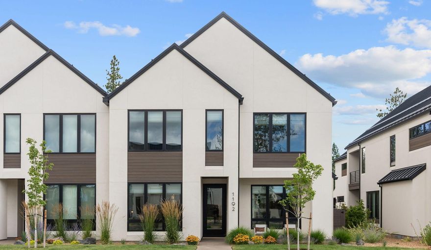 This modern Trove Townhome is located in Bend's sought after Discovery West. Scandinavian inspired design, clean lines, and quality finishes define this thoughtfully crafted home. The main level features a spacious great room with a gas fireplace, custom built-ins, and hardwood floors. The chef's kitchen offers a 6 burner Wolf range, oven and microwave, Sub Zero refrigerator, large island, and walk-in pantry. A covered patio off the dining area is perfect for entertaining. Upstairs has a primary suite with vaulted ceilings, a tile walk in shower and a large walk-in closet, a large second great room with beverage center, two large bedrooms, a full bath, laundry room, and a covered upper patio with heaters, and epoxy garage floor. $80 k in owner upgrades include high end window coverings, designer lighting, new patio decking, and whole house humidifier. Earth Advantage Certified.