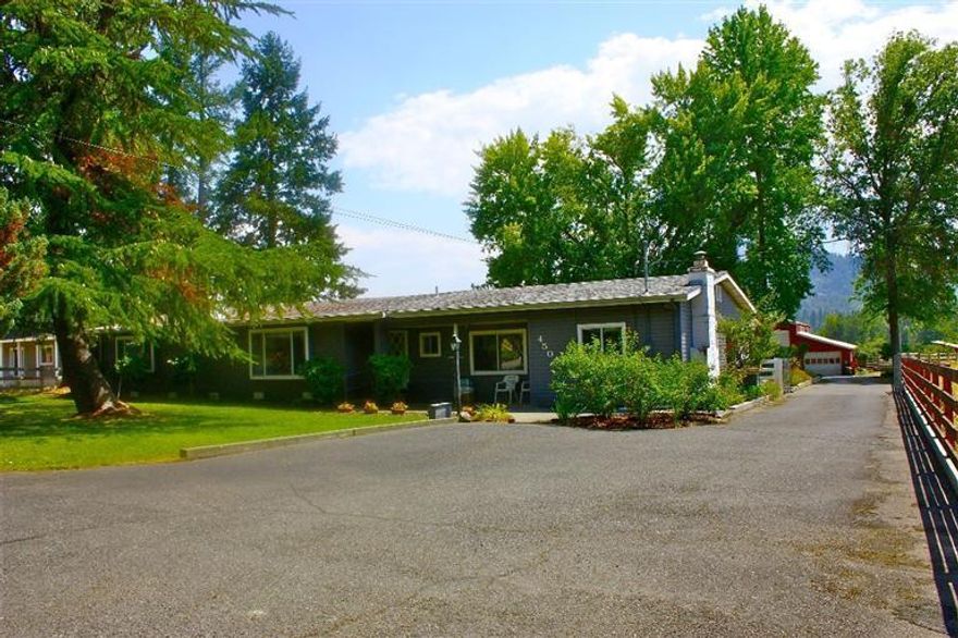 Here is a ranchette with 9.83 irrigated ac. in one of the best rural areas of Josephine Co.. Minutes from downtown and the new medical facilities, this 2600 sq ft home has room for livestock or run a great hay operation. Property is fenced / cross fenced, has a large barn/studio/shop that has tons of storage and garages. A 2-car detached garage, with an additional carport for the tractor. Private cool back yard,large garden are, gated drive, and more outbuildings adds to the entire package to give you peaceful enjoyment year round. Come take a look, you won't be disappointed.