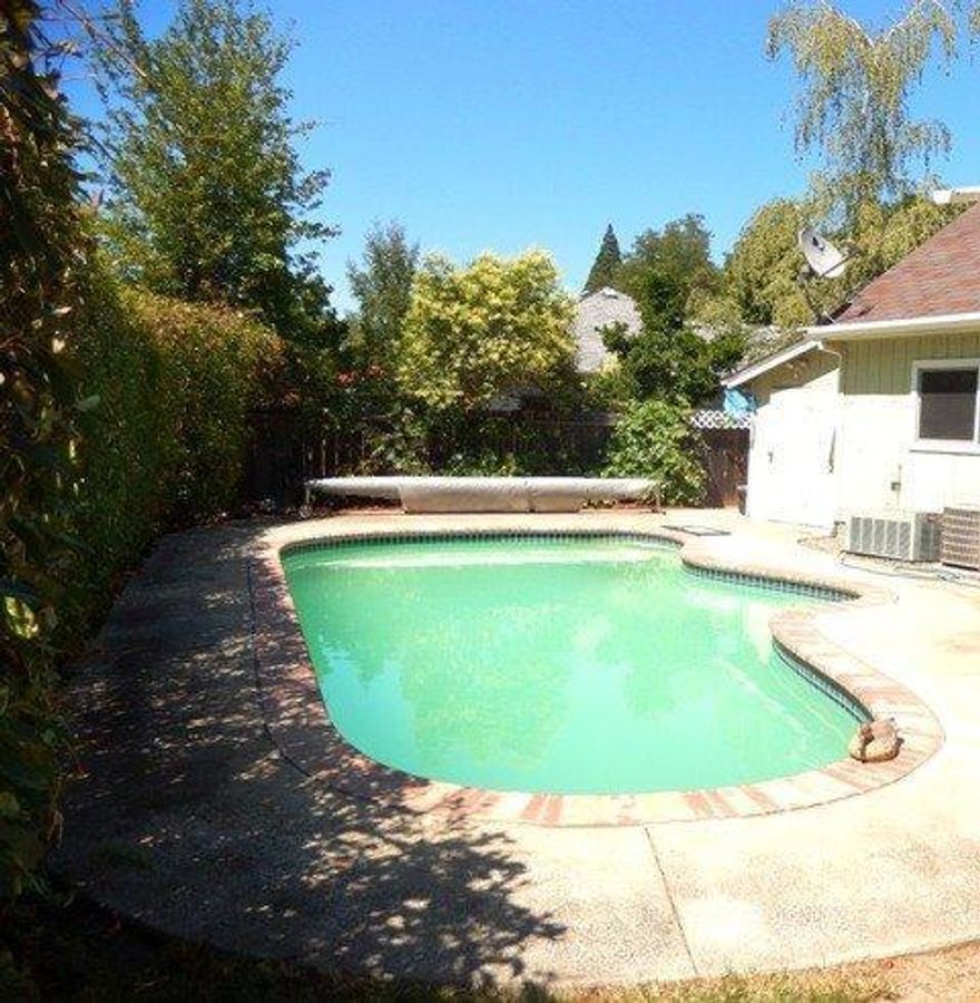 Lots of bedrooms(5), check, lots of pool,check, lots of yard, check, that only spells one thing. Cool nights, lots of BBQ's, and lots of fun. Wonderful open floor plan with a enclosed sunroom, and two large bedrooms up-stairs. Kitchen has great appliances with a large refrigerator and island. Lots of cooks can be in this kitchen. Big backyard with solar heated pool and hot-tub.