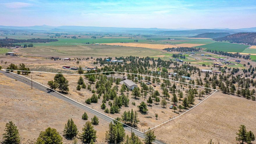 Amazing property with one-of-a-kind views. Nestled on the south slope of the hill, views reach out across the Prineville Valley. Property is at the end of the road-very private. 4 bedroom (den could be 5), 2 1/2 bath home with many updates & large vaulted living room gives this home lots of reasons to stay. Split bedroom plan offers unique multi-generational living. Lots of windows lets natural light flow through the living space. Large, covered deck runs along the south side of home providing additional outdoor living, ability to enjoy the view & appreciate the pond. Mutli-levels of deck create more spaces for outdoor enjoyment, including hot tub, area for patio fire pit, uncovered space to enjoy sunny afternoons & evening stars. Large (30'x84') shop includes 14' garage doors off each end for drive-thru ease; covered parking for all the toys; inside is set up for shop, storage & more. Property has been meticulously maintained including perimeter fencing & trimmed trees. More to see!