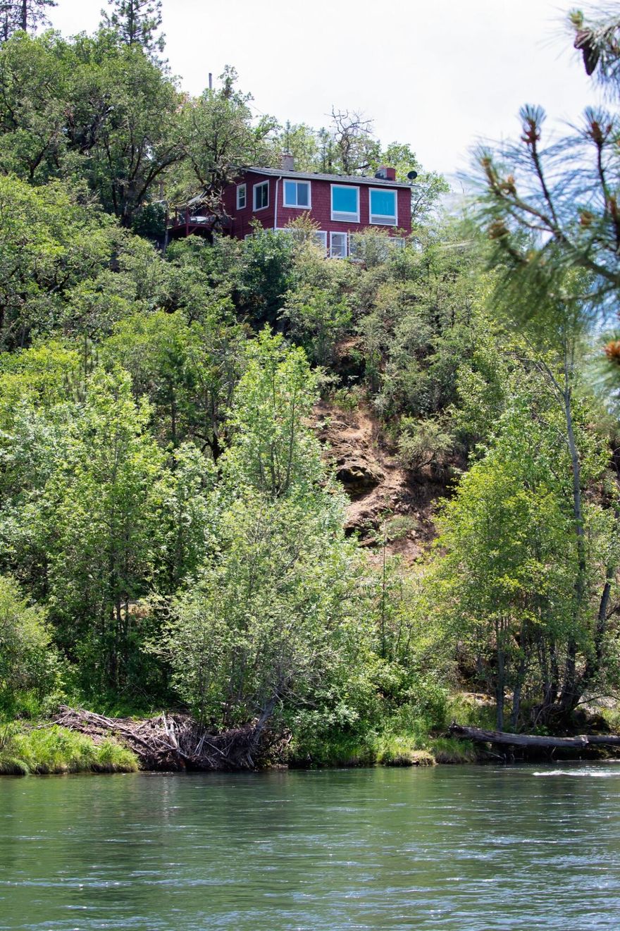 Welcome to life on the Rogue River in Shady Cove, the views are incredible. This unique property offers one bed, one bath on main living floor with one bed, one bath in daylight basement apartment. Main floor has many upgrades with soap stone, granite counter tops and hardwood, tile floors. Per seller well is 4 gallons a minute with 1000 gallon holding tank. Home features water filtration system. Plenty of room for RV Parking with detached garage.