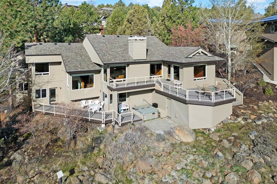 Situated with aerial views of the Deschutes River, this home offers some of the most unique and rare views a Bend neighborhood can offer. Whether you're enjoying the scenery from multiple rooms within the home or savoring a morning sunrise from the newly updated Trex deck, you'll always be close to this home's natural setting. If convenient access to downtown is high on your priority list, this home is just a short distance from the action, while still providing a peaceful retreat at the end of the day. From the property, you have direct access to the Deschutes River Trail, which leads you south to downtown or north to the nearby Sawyer Park. This well-maintained home's standout features include a gas fireplace, vaulted ceilings with an open-concept living space, and a layout that separates the primary suite from the guest bedrooms. Come home to the tranquility of river views every day. Schedule your private showing today.