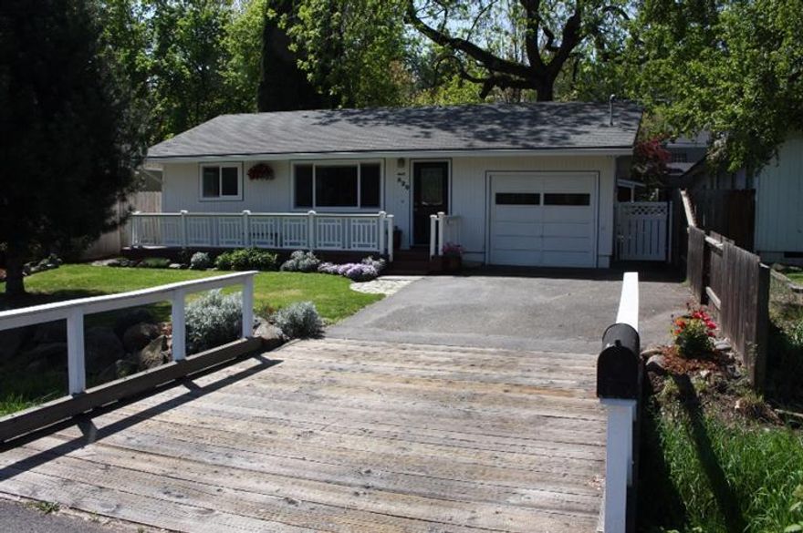 Enchanting garden cottage just blocks from downtown Jacksonville. Indoors you will find oak floors, vinyl windows, and a newly remodeled kitchen with new cabinets, appliances and garden window. The spacious laundry room and one-car garage offer extra storage.There is a possibility that the laundry could be a 3rd bedroom, buyer to do own due diligence. Outside is charming with a driveway bridge over the creek, newly painted front deck,and beautiful landscaping. The backyard is absolutely magical with mature trees, Rhododendrons, Camellias, Japanese Maples, a bubbling water feature, and a garden bar ideal for entertaining. This is the perfect home to enjoy the coveted Jacksonville lifestyle.