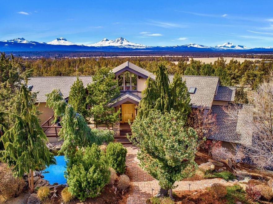 MOTIVATED seller moving out of state! Spectacular 3,861SF Grandridge Estate on 9.9 acres w/ some of the best panoramic Cascade Mtn. Views in Central Oregon! Main level has great room style floor plan w/huge vaulted ceilings, a master bedroom suite w/private patio & a 2nd jr suite w/ it's own bathroom. Downstairs could be a second living space w/ private entrance, living room, bedroom, bathroom, kitchenette & custom built wet bar.  Upstairs offers a loft-style office w/gorgeous views. Home has been thoughtfully upgraded & improved throughout including: brand new kitchen-aid appliance package, $300,000 landscape package with koi pond, over 50 trees that create a private oasis, huge fully enclosed garden w/ fruit trees & 8 raised garden beds all with automatic irrigation, new well pump with over 24 gpm, new 40-year roof, 4 energy efficient mini-splits, 6 zones of radiant floor heating, new hot water tank with insta hot, extra deep garage with storage area, 3 decks & fully paved driveway.