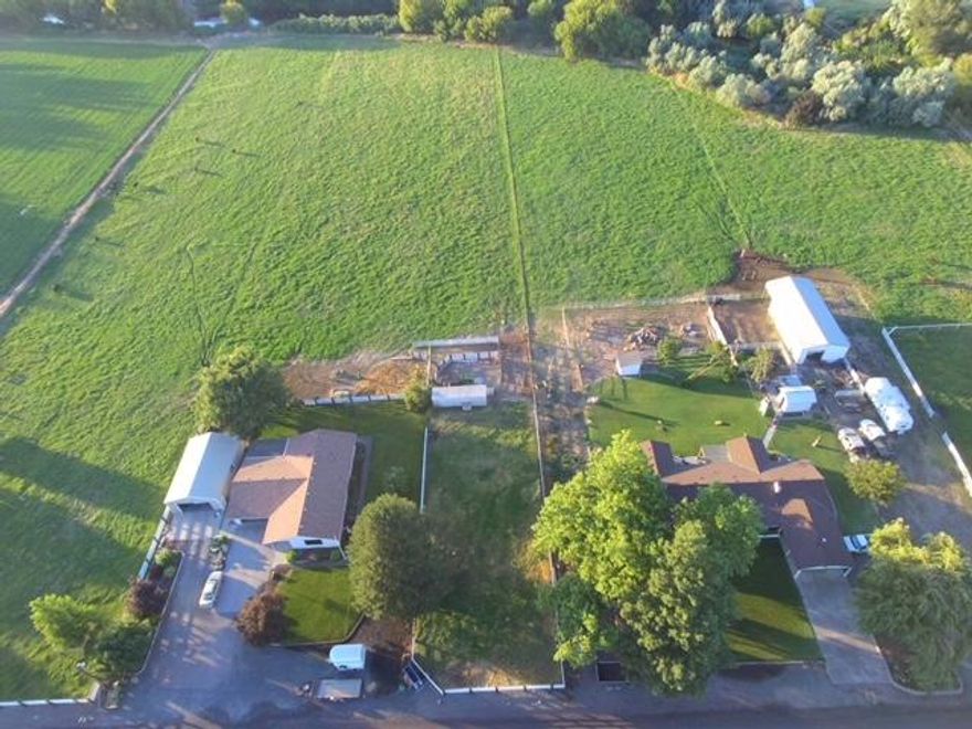 Beautiful Ranch style home located in the country on 5.05 fenced and crossed fenced with approx. 4.6 acres irrigation with HID.  Newly painted in 2021, new roof in 2016, new hot water heater 2020, RV parking and electrical 30 AMP hookup at 24x60 shop/barn.  Corrals, fenced garden area, no neighbors along whole East side of property.  Granite counter tops, fireplace, jetted tub, walk in closets, and large front and back yards perfect for entertaining.  Pump house for private domestic well, mature trees, quiet dead end road, irrigation is solid set and on electric timers!  Home has LED lights throughout and was remodeled in 1994 and some in 2014.  Property borders Umatilla River with access to the river. Too many amenities to list here!