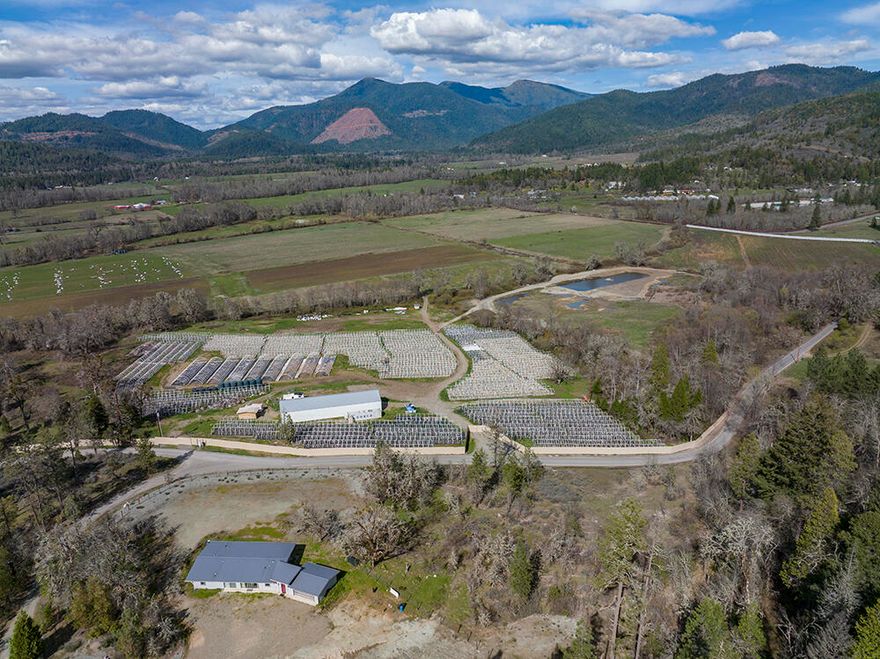 Exclusive Farm in the Illinois Valley! This Southern Oregon dream sits on 106 acres with 80 +/- acres of Water Rights and STUNNING views! Tucked away from the road and nestled between Oregon hills, this property offers a beautiful 2016 sqft home (completely remodeled in 2017) boasting 3 BDs/3 BTHs, high-end finishes, newer 2-car garage and a modern, open layout. The self-sustaining farm includes a 40x120 insulated shop with 400amp, slab floor, and large commercial grade roll up doors! There's also a large pond reservoir with 3-phase 20 horse pump, a year round spring, high producing well, 102 permitted hoop/greenhouses and (2) 5000g gravity fed tanks with additional water lines as backup. Land is flat and useable, is fully fenced and offers enough space for a small farm with plenty of pasture for animals! Don't miss out on this rare opportunity, call/text listing agent to view this incredible wine country gem today! Owner Carry terms available! Buyer to do own due diligence.