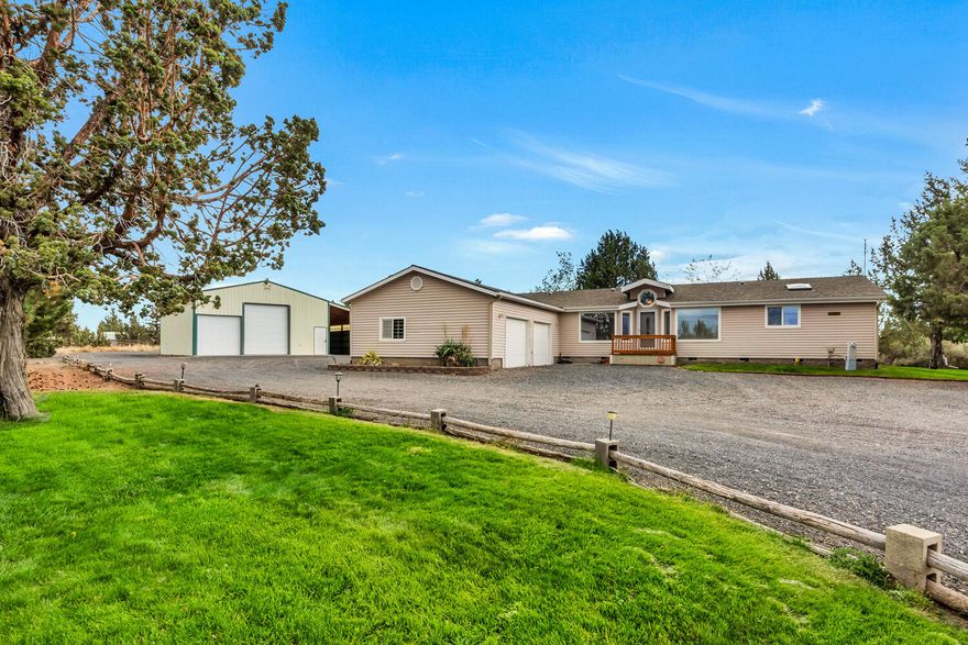 Begin each morning with mountain views through your kitchen window, spend all day creating in your 1,440 SF shop, and relax every evening on your large, shaded deck. All of this awaits you in a quiet corner of Crooked River Ranch. Well-maintained manufactured home includes 3 bedrooms, 2 baths and a vaulted living-kitchen area with gas fireplace & access to the oversized deck. Built on a permanent foundation &  equipped with an attached 2 car garage, this home awaits your inspired vision. Dream shop features extra tall ceilings, concrete floors, abundant storage racks, and a separate, covered RV storage bay. This flat 5 acre parcel features scores of mature junipers, pond with gently cascading waterfall, underground piping from shop to garage for compressed air & generous gravel driveways. Crooked River Ranch owners enjoy access to the swimming pool, tennis/pickleball courts, 18-hole golf course, RV Park, numerous trails & parks, horse arena and the region's unparalleled natural beauty.