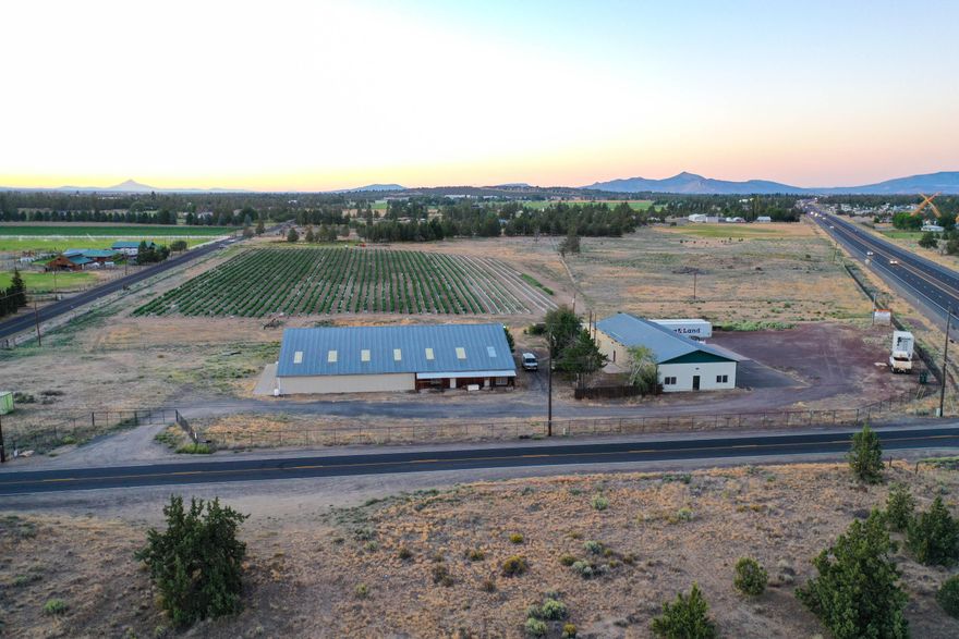 Back of market, no fault of property. New well and pump. Great opportunity for a boutique farm with exceptional exposure for advertising along Hwy 97 to sell agricultural related products to the public.  ODOT records approximately 40,000 vehicles drive by daily. 24.63 acres of flat land, highway 97 frontage with 7 acres of Swalley irrigation water rights and potential for more. Certified USDA Organic and Oregon Tilth.  The property includes a 12,544 sq.ft+/- warehouse with an office space and storage and an approx. 4,752 sq.ft.+/- building which contains an office space, storage and shop area. Also included is a 2,405 sq.ft.+/- home, 3 car garage and Cascade views. EFU Zoned with building upgrades which includes, food grade materials on walls and ceilings, electric and HVAC.  Live out your dream, build your business and thrive at this location. Incredible location with many opportunites.