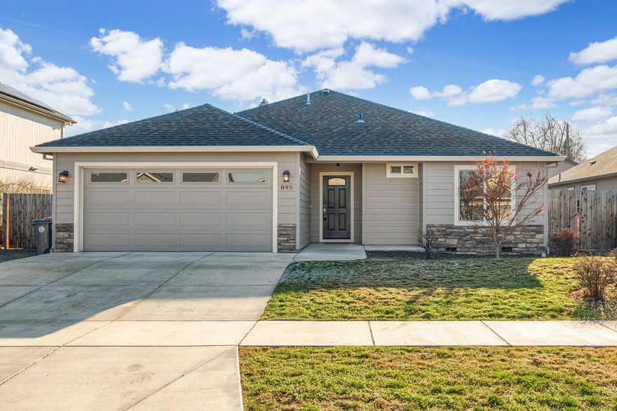 Welcome to this 2017-built home in Medford, centrally located with quick access to shopping, schools, parks & more. Featuring 1,429 sf of thoughtfully designed space, this residence offers a great blend of quality, convenience & comfort. You will love entering the home to a bright spacious open floor plan. The Kitchen has plentiful storage space, pantry & granite counters. This home features great separation of space between the 3 bedrooms & 2 baths, ideal for both entertaining & relaxing. The primary bedroom features a walk in closet, full bathroom & easy access to a separate laundry room. Step outside to the covered back patio & fenced yard, providing privacy & opportunity for gardening or other outdoor activities. The property is equipped with sprinklers for easy maintenance, & there is space on the side yard to possibly park a small boat or make use of extra storage possibilities. This Medford home is clean, stylish & ready for you.