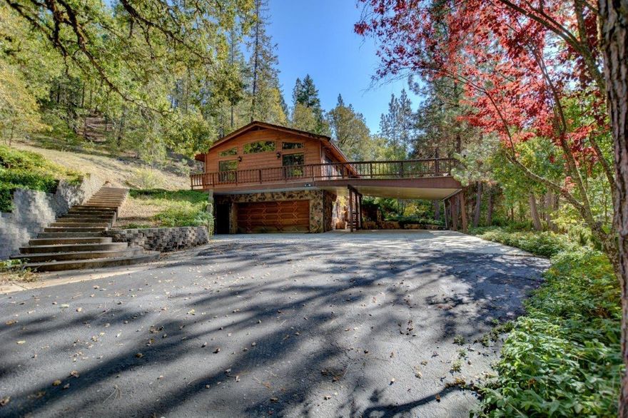 Private and peaceful, this 8-acre sanctuary with flowing creek is backed by government land. The 2,691 sq. ft. 3 bedroom, 2.5 bath, split level home boasts a spacious kitchen, built in subzero refrigerator, a large family room with fireplace that opens to a large deck, a central vacuum system, and a bonus room downstairs that was used for animals leads to a fenced-in yard area. The outside features a large shop, the ultimate man cave and a dog kennel that could be easily converted to stalls. A portion of the property is fenced in to accommodate animals. Plenty of space to create your dreams!