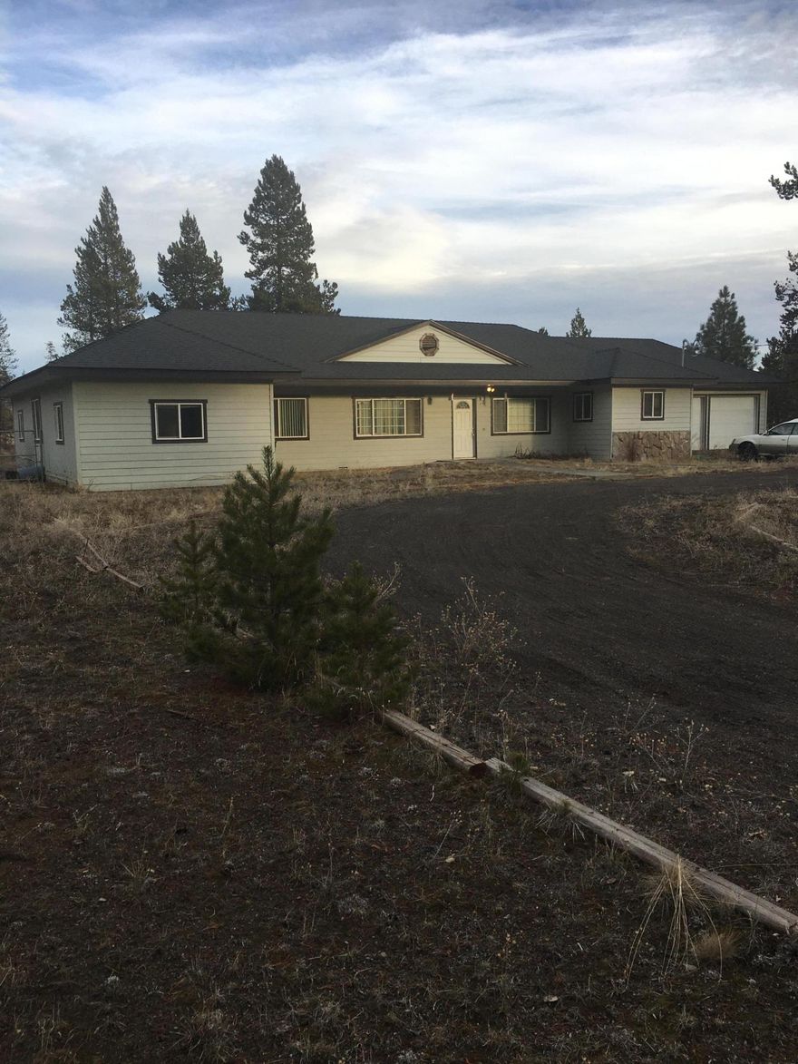 Beautiful,  spacious,  4+ bedroom,  2 bath, open floor plan, home, just awaiting the buyer who recognizes the  potential  value that can be achieved  by attention to deferred maintenance due to long term health issues of owner since 2004.  This Beautiful 2724 Sq ft home can be restored to beauty, and become the icon it's framework represents!  A home with many possibilities for family, with separated master bedroom touting vaulted ceilings, large walk in closet, and French doors opening onto the back deck.  The oversized 2 car garage sports an additional game room, studio, or shop area, opening up even more possibilities for expanded living.  A fully cyclone fenced, huge back yard is included with this 1.16 acre lot that sports a view of Paulina Peak.  
This home is waiting for the  buyer who is ready to invest and make their dream home become a reality in Beautiful  Central Oregon!